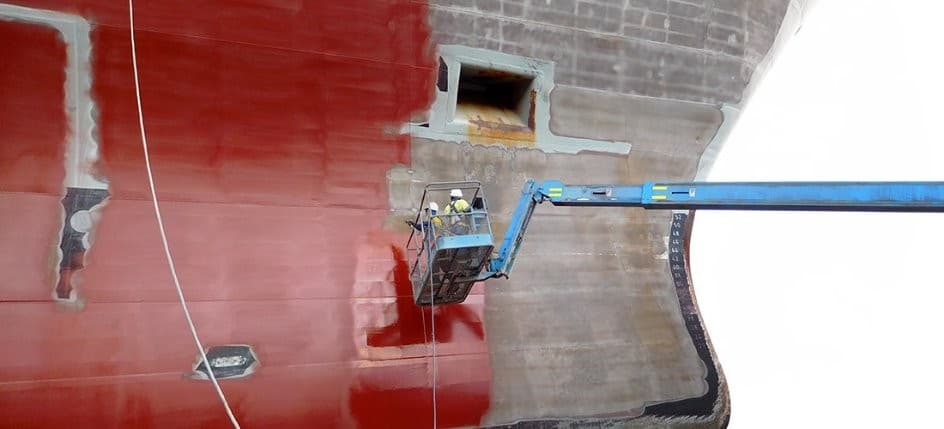 Protective coating application on naval vessel